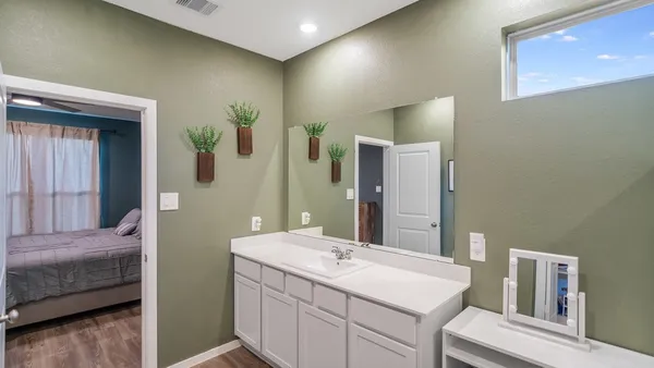 a en suite bathroom with a sink and mirror