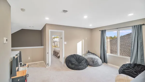 a bedroom with a large bed and a large window