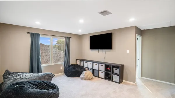 a living room with a flat screen tv and a flat screen tv