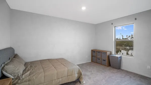 a bedroom with a bed and a window