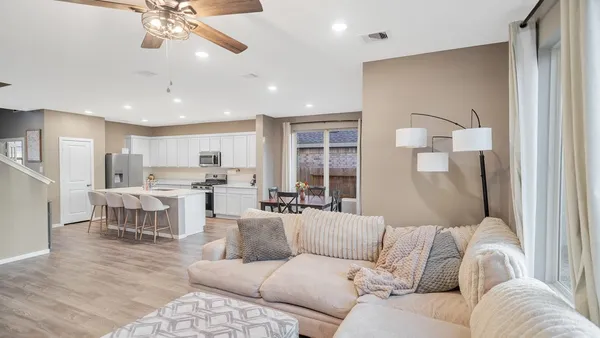 a living room with furniture and kitchen view