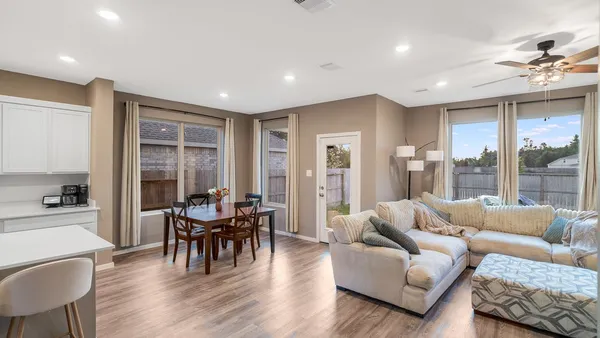 a living room with furniture and wooden floor