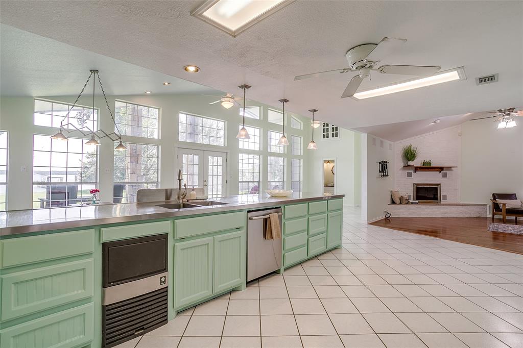 11484 Moran Road Azle, TX 76020 - Photo 40 of 40 Kitchen with stainless steel countertops, ceiling fan, open floor plan, green cabinets