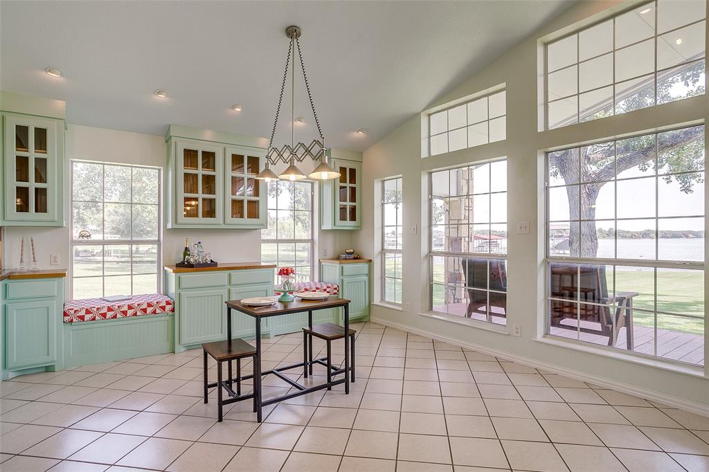 11484 Moran Road Azle, TX 76020 - Photo 15 of 40 Dining space featuring vaulted ceiling, a water view, light tile patterned flooring, and recessed lighting