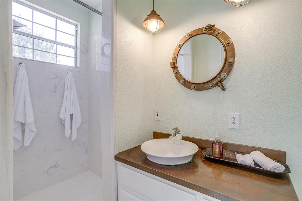 11484 Moran Road Azle, TX 76020 - Photo 17 of 40 Full bathroom featuring vanity, a marble finish shower, and a textured wall