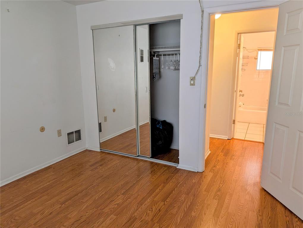 5908 17th Street West, Unit C36 Bradenton, FL 34207 - Photo 14 of 28 an empty room with wooden floor and a window