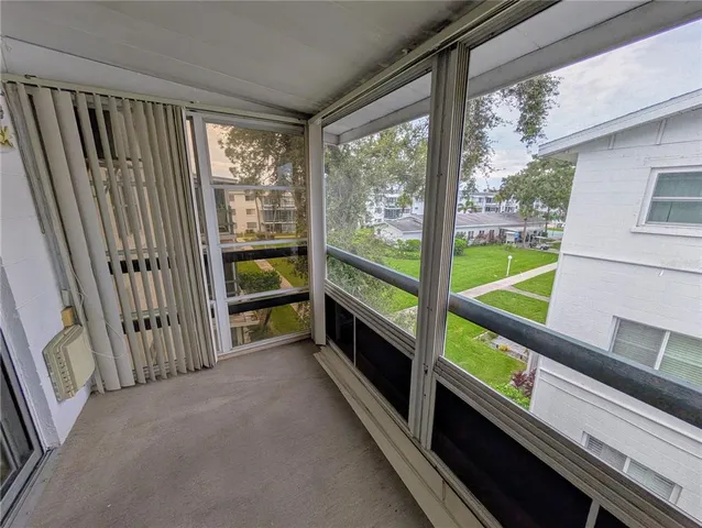 a view of a room with wooden floor and windows