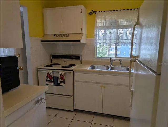 a kitchen with a stove and a sink