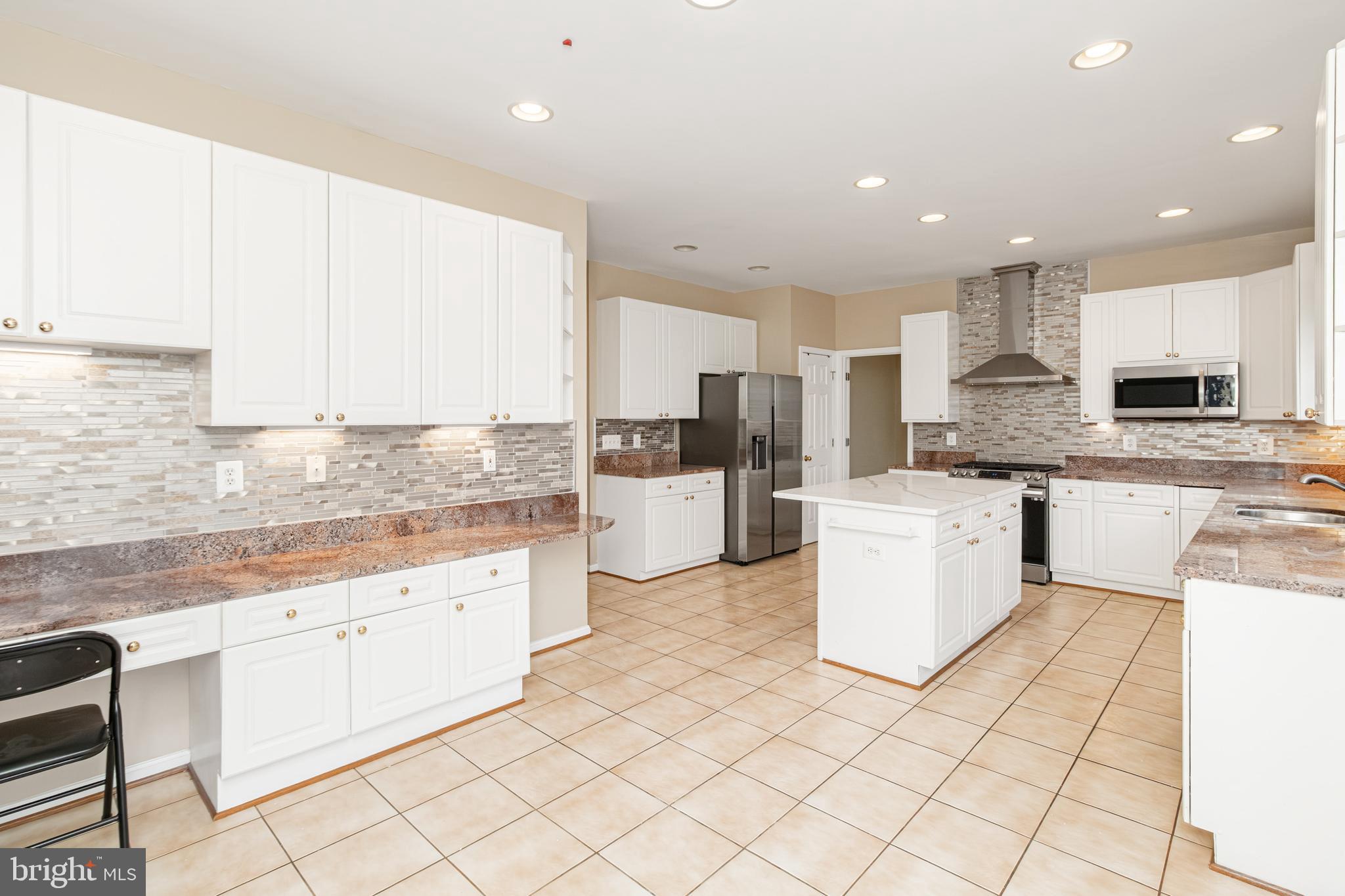 6239 Willowfield Way Springfield, VA 22150 - Photo 11 of 45 a kitchen with a sink a counter top space cabinets and stainless steel appliances