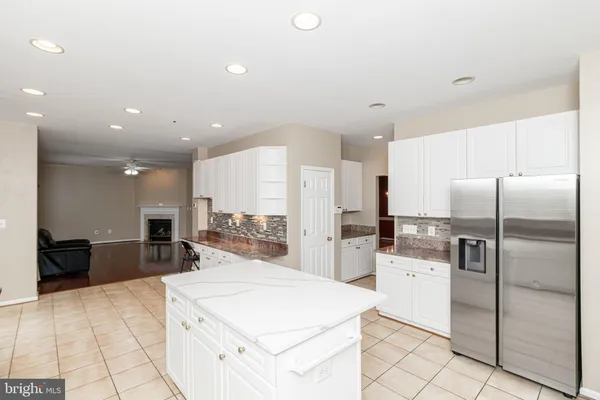 a kitchen with stainless steel appliances a refrigerator sink and microwave