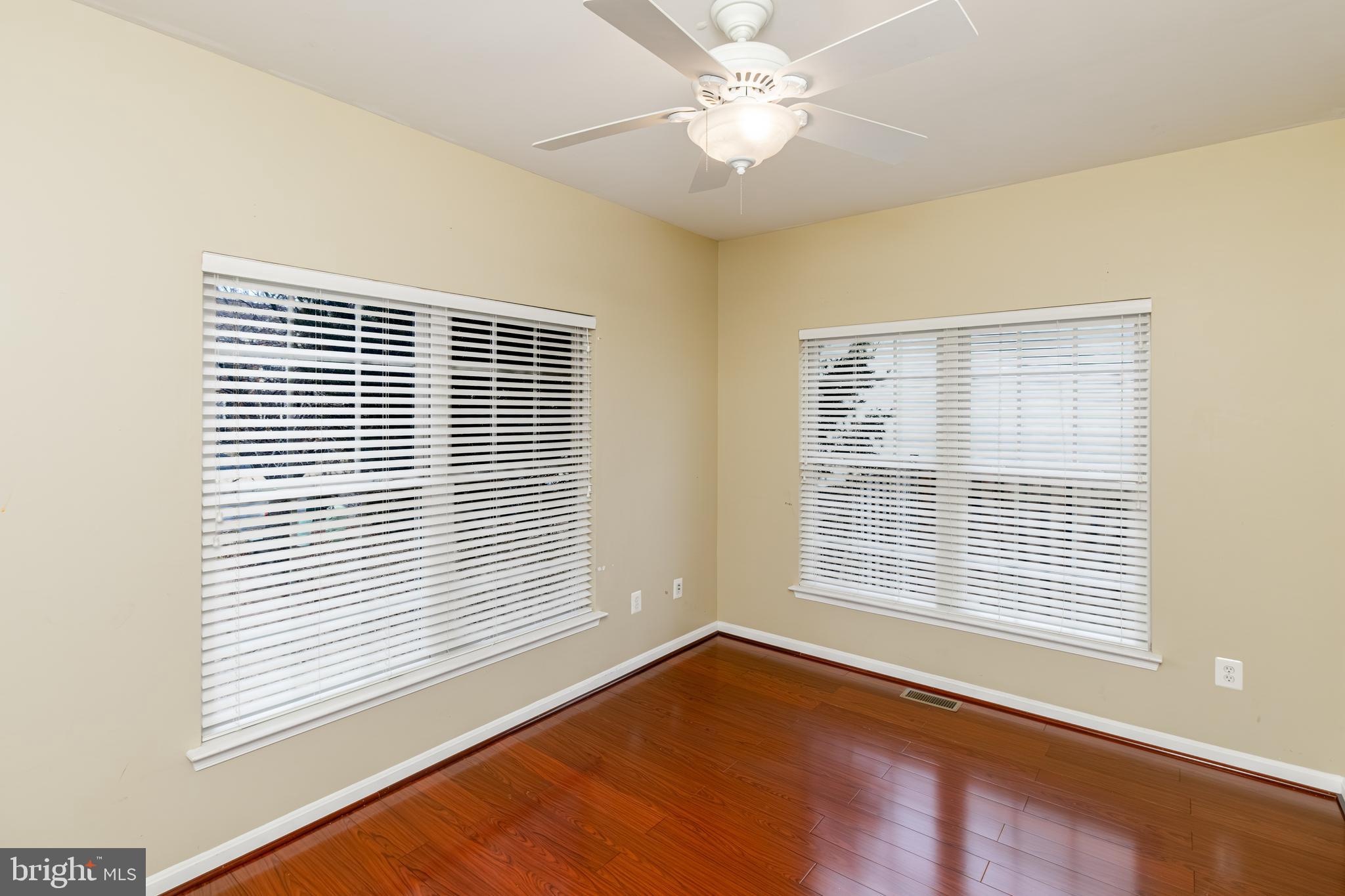 6239 Willowfield Way Springfield, VA 22150 - Photo 22 of 45 a view of an empty room with a window and wooden floor