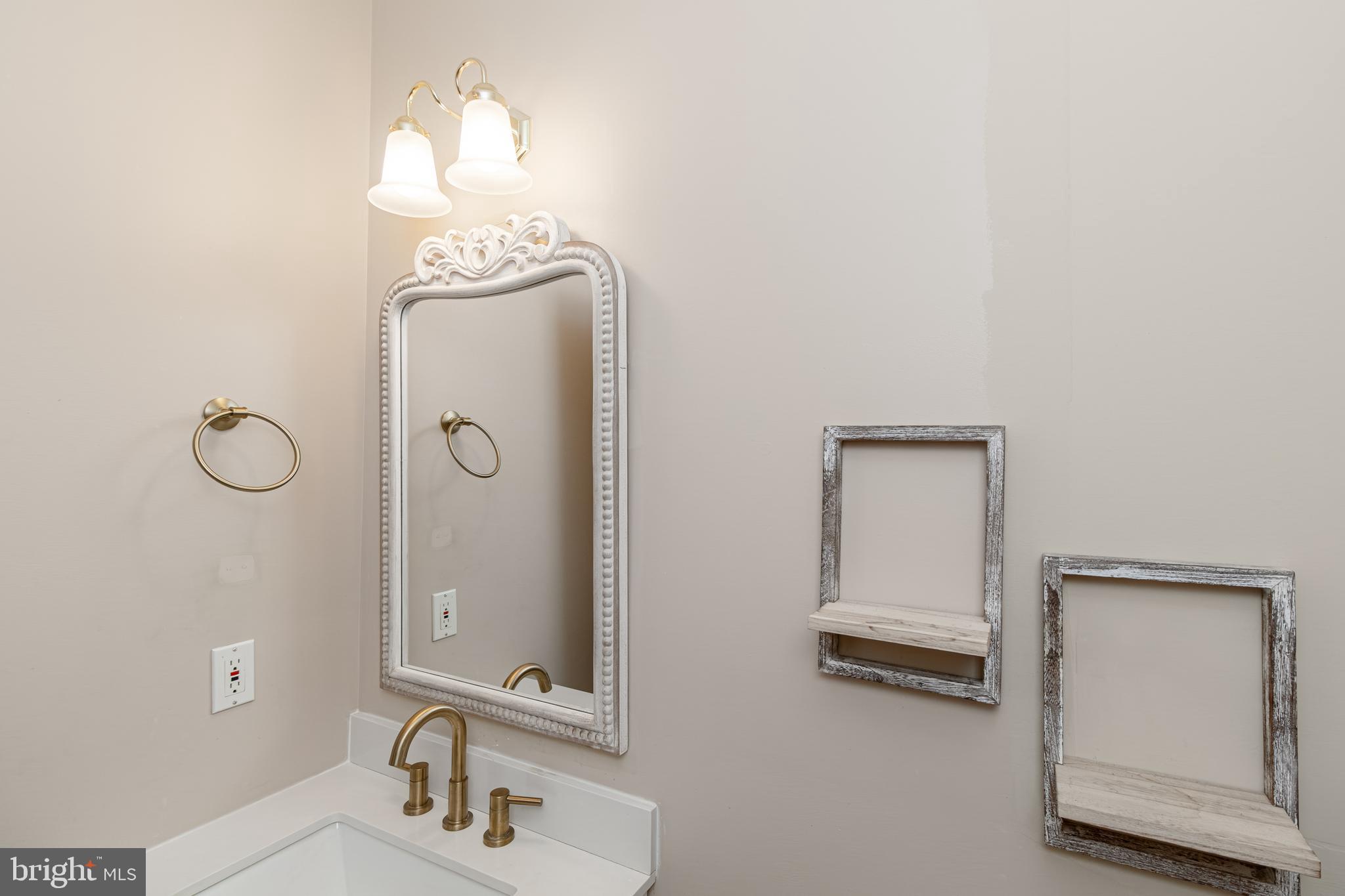 6239 Willowfield Way Springfield, VA 22150 - Photo 24 of 45 a bathroom with a mirror and a sink