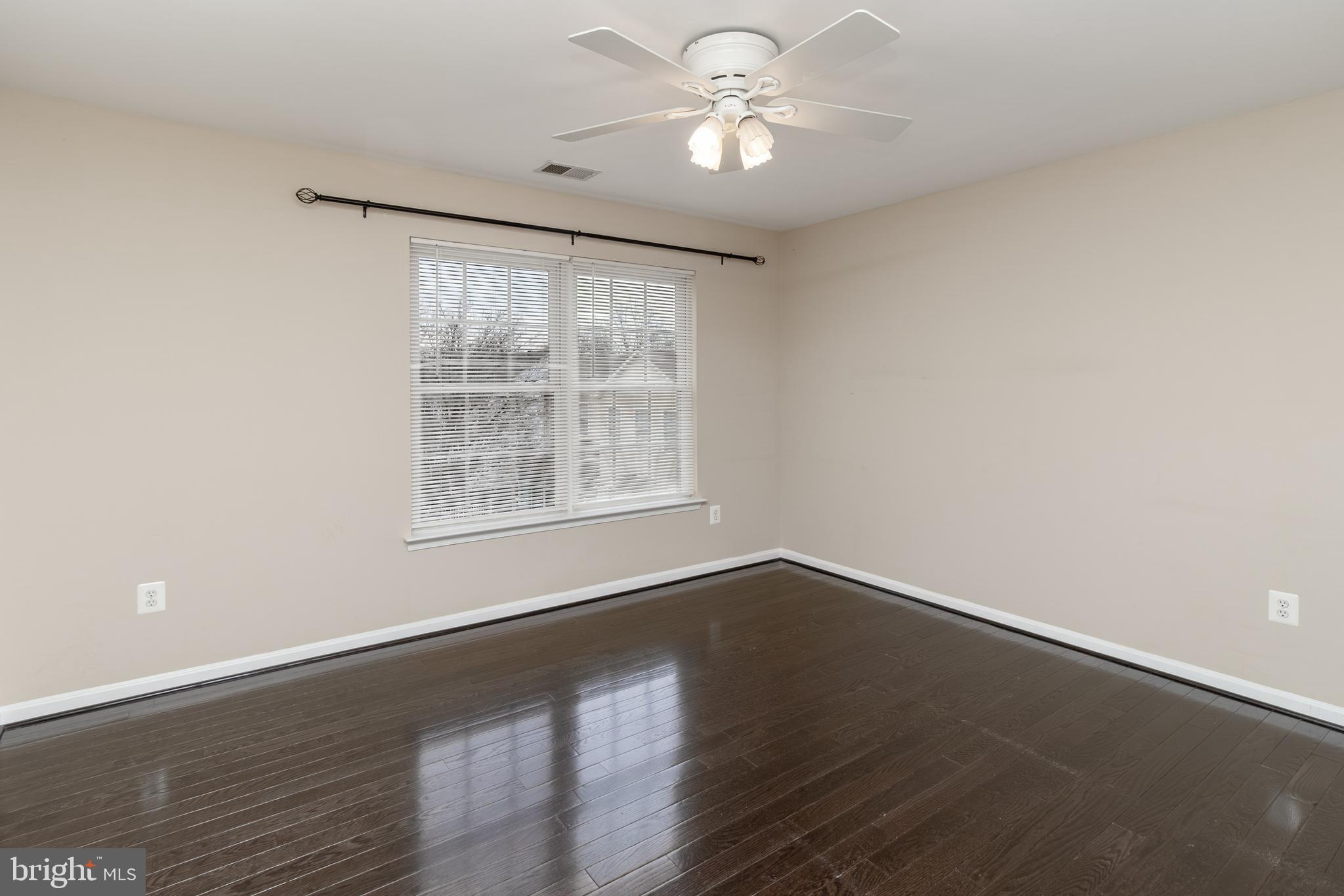 6239 Willowfield Way Springfield, VA 22150 - Photo 29 of 45 an empty room with wooden floor fan and windows