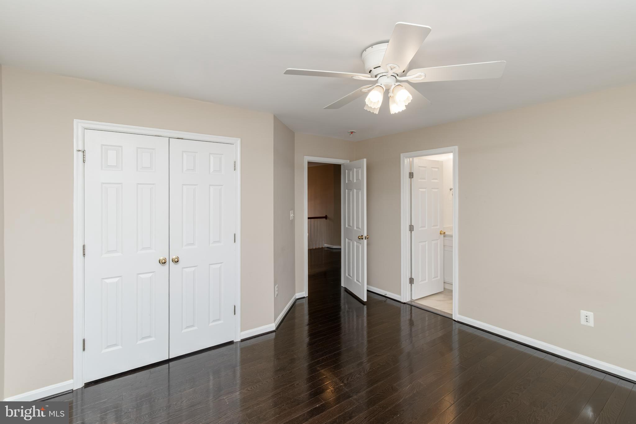 6239 Willowfield Way Springfield, VA 22150 - Photo 30 of 45 an empty room with wooden floor and ceiling fan