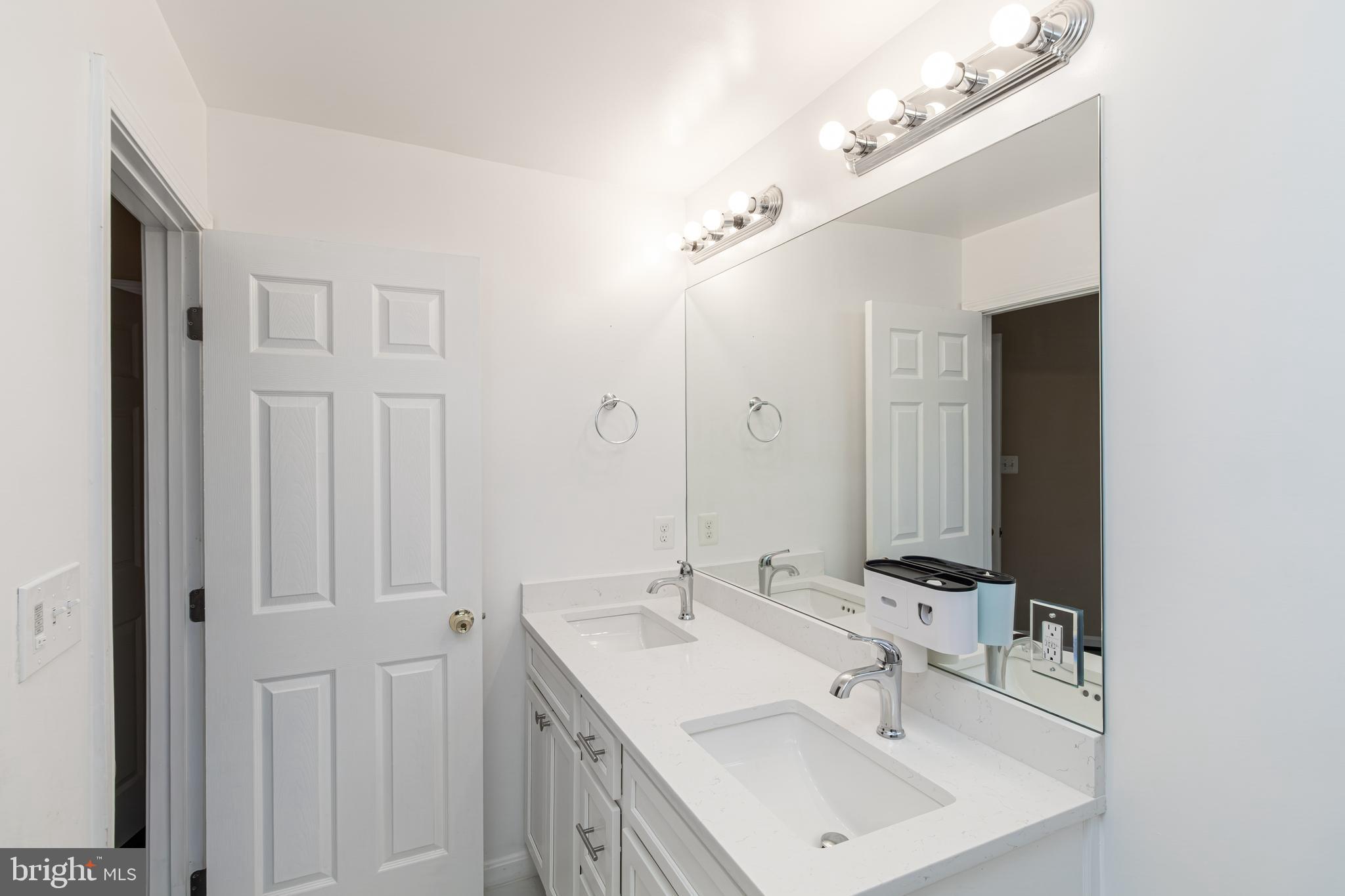 6239 Willowfield Way Springfield, VA 22150 - Photo 31 of 45 a bathroom with a sink and a mirror