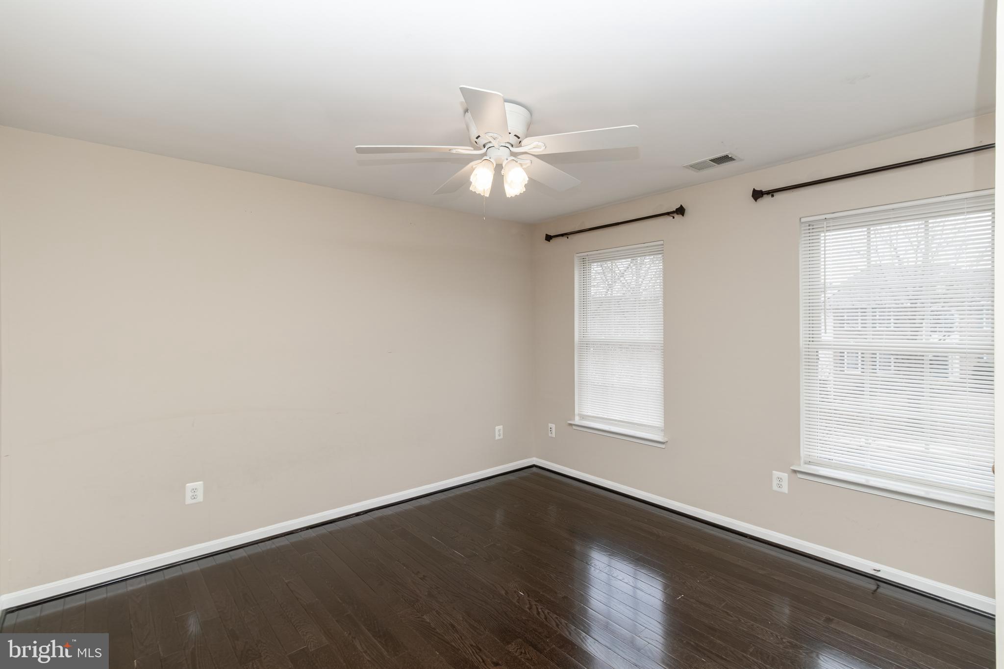 6239 Willowfield Way Springfield, VA 22150 - Photo 32 of 45 an empty room with wooden floor fan and windows