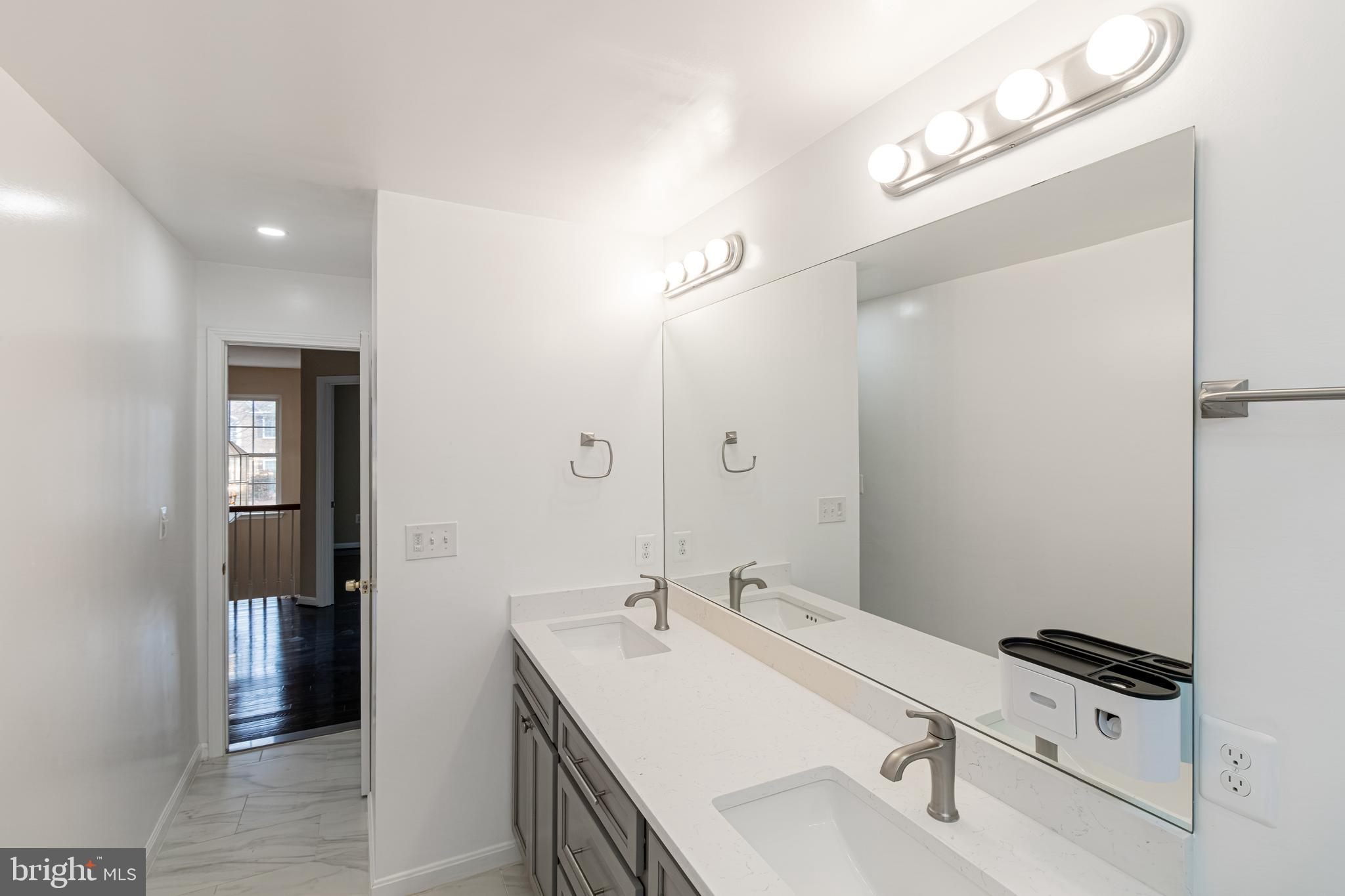 6239 Willowfield Way Springfield, VA 22150 - Photo 36 of 45 a bathroom with a sink and mirror