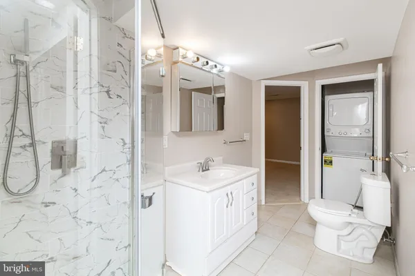a spacious bathroom with a bathtub sink mirror and toilet
