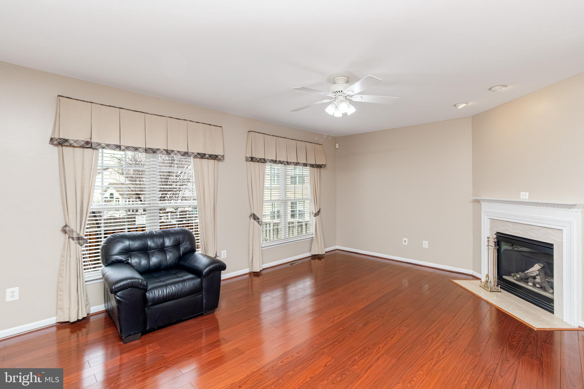 6239 Willowfield Way Springfield, VA 22150 - Photo 8 of 45 a living room with furniture and a fireplace