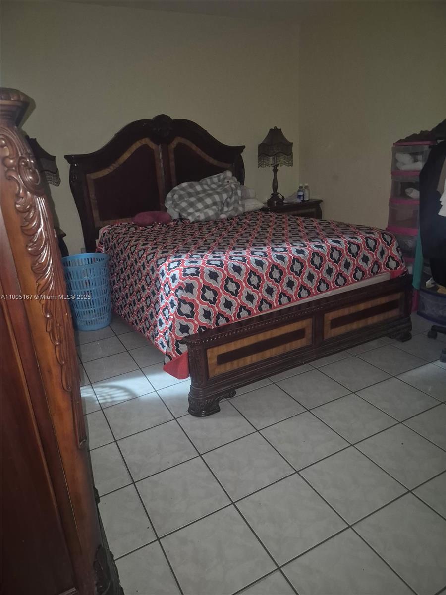 1850 West 56th Street, Unit 2410 Hialeah, FL 33012 - Photo 11 of 12 a bedroom with a bed and a window