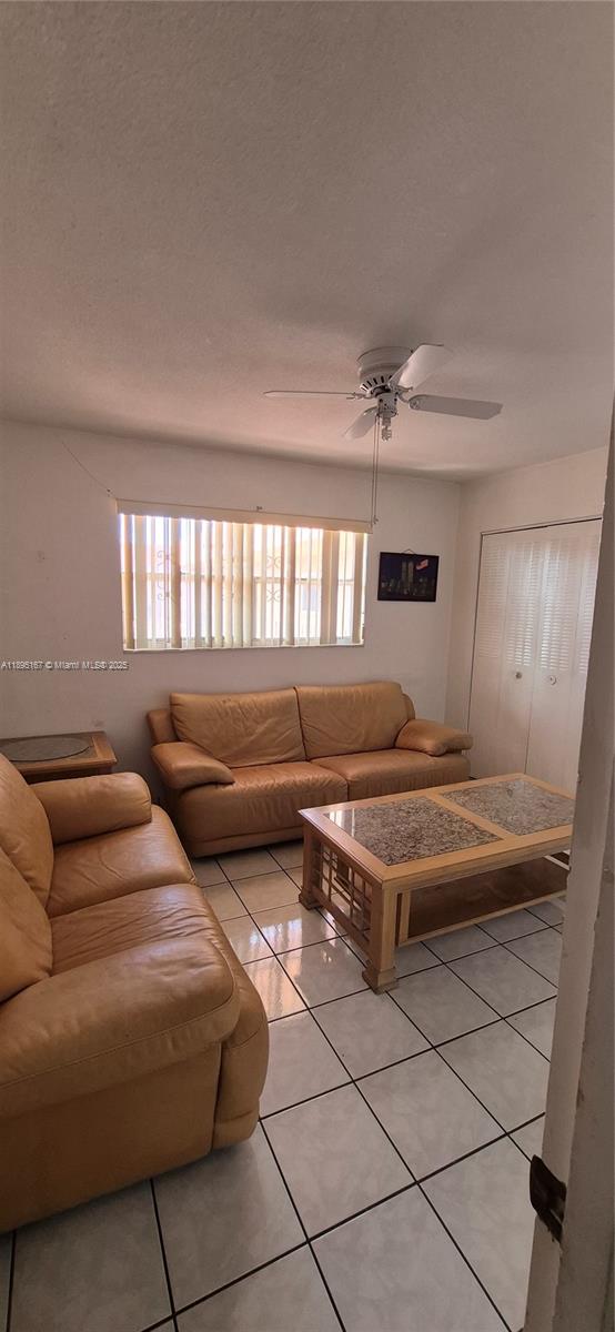 1850 West 56th Street, Unit 2410 Hialeah, FL 33012 - Photo 9 of 12 a living room with furniture and a window