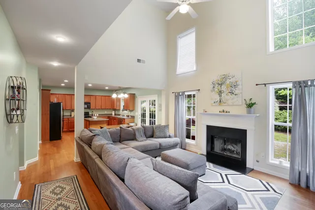 a living room with furniture and a chandelier