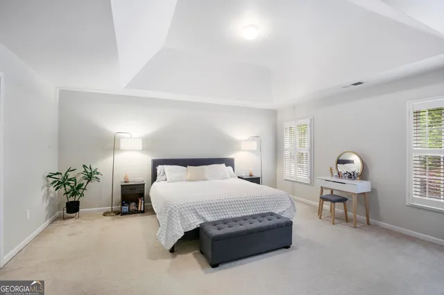a bedroom with a bed and a potted plant