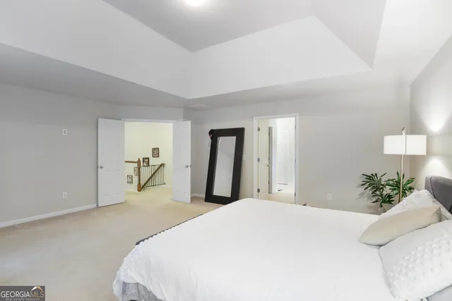 a bedroom with a bed and glass window