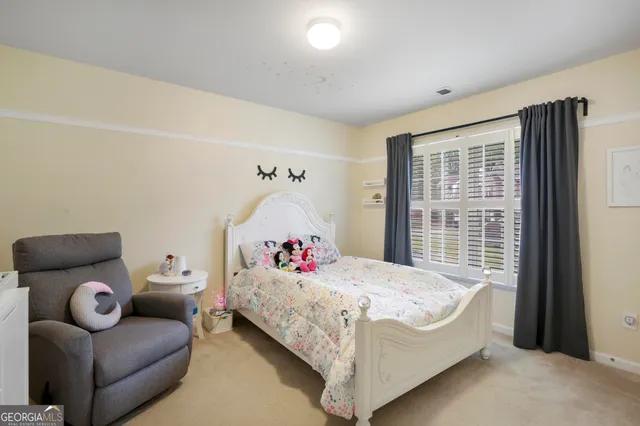 a bedroom with a large bed and a large window