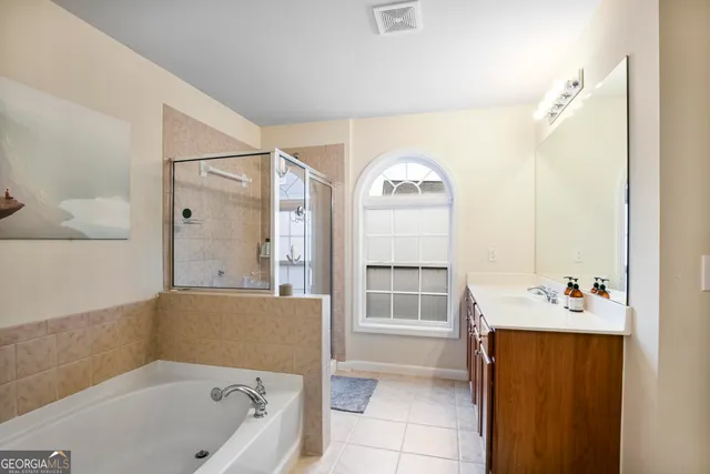 a kitchen with stainless steel appliances granite countertop a refrigerator a stove top oven a sink dishwasher and a refrigerator