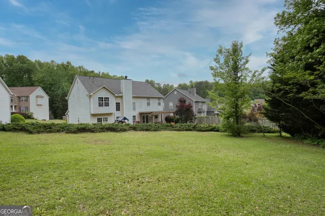 a backyard of a house with outdoor seating