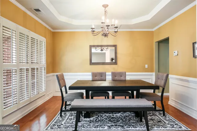 a view of a dining room with furniture window and wooden floor