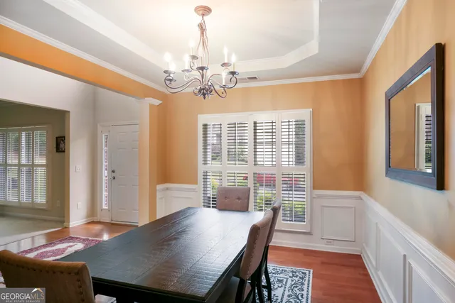 a view of a dining room with furniture window and wooden floor