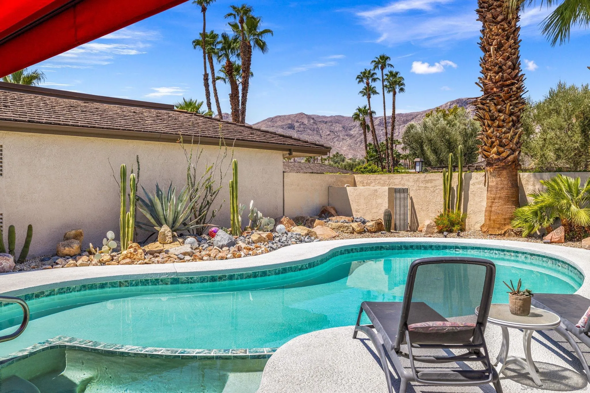 142 Yale Drive Rancho Mirage, CA 92270 - Photo 26 of 72 a view of a backyard with table and chairs potted plants and palm tree