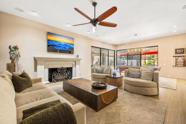 a living room with furniture fireplace and a flat screen tv