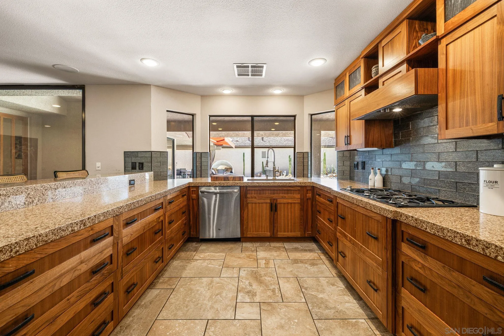 142 Yale Drive Rancho Mirage, CA 92270 - Photo 31 of 72 a large kitchen with stainless steel appliances granite countertop a large counter top a stove and a sink