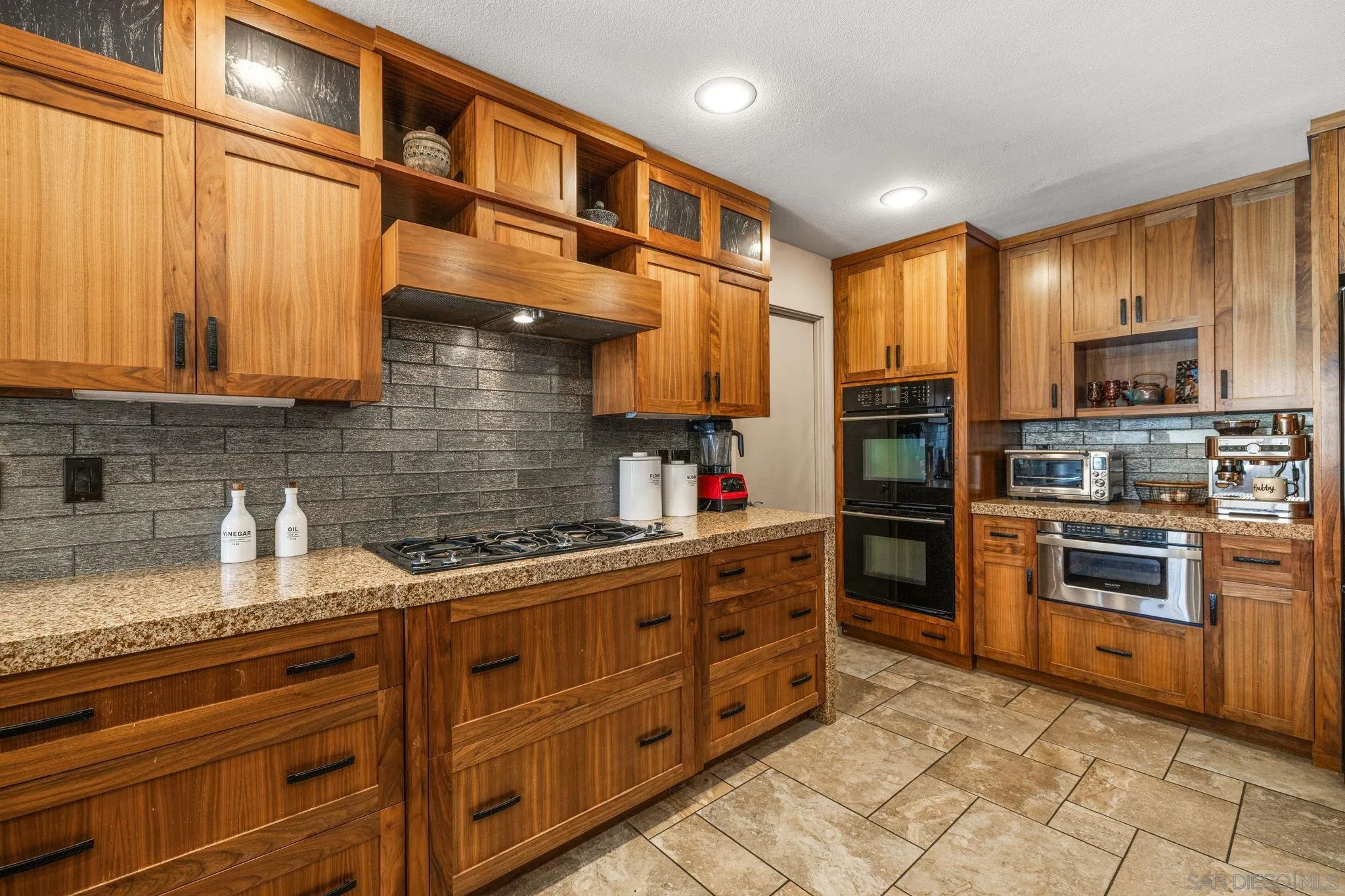 142 Yale Drive Rancho Mirage, CA 92270 - Photo 33 of 72 a kitchen with stainless steel appliances granite countertop a stove a sink and a refrigerator