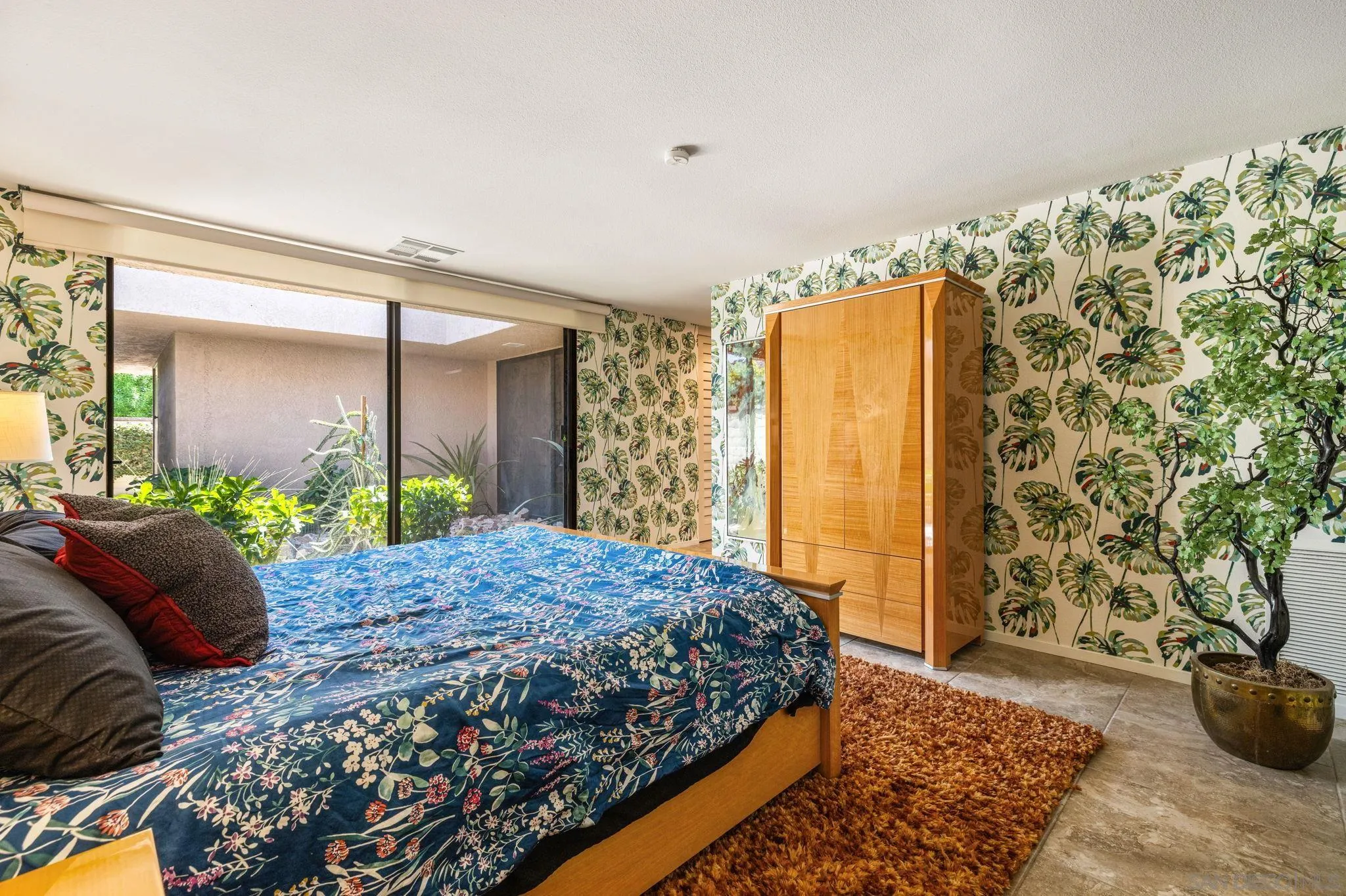 142 Yale Drive Rancho Mirage, CA 92270 - Photo 42 of 72 a bedroom with a bed and a painting on the wall