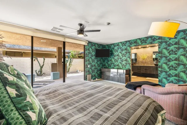 a front view of a house with a garden and potted plants