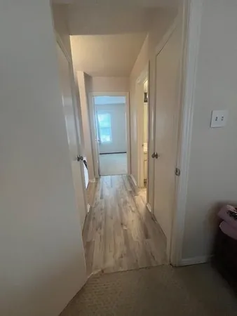 a view of a room with wooden floor