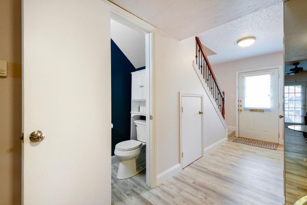933 Roaring Springs Road Fort Worth, TX 76114 - Photo 13 of 25 a view of a hallway with wooden floor and staircase