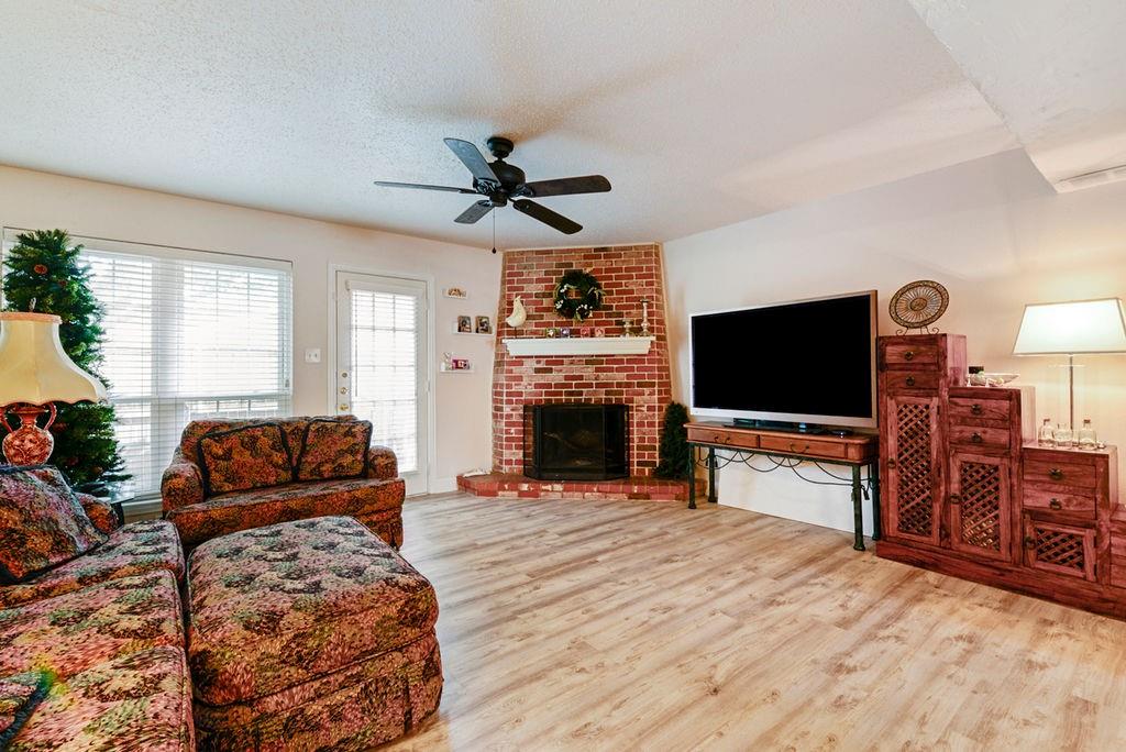 933 Roaring Springs Road Fort Worth, TX 76114 - Photo 14 of 25 a living room with furniture a flat screen tv and a fireplace
