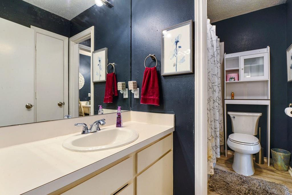 933 Roaring Springs Road Fort Worth, TX 76114 - Photo 17 of 25 a bathroom with a sink and a mirror