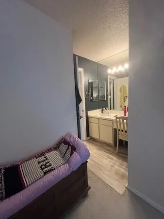 a living room with furniture and a mirror