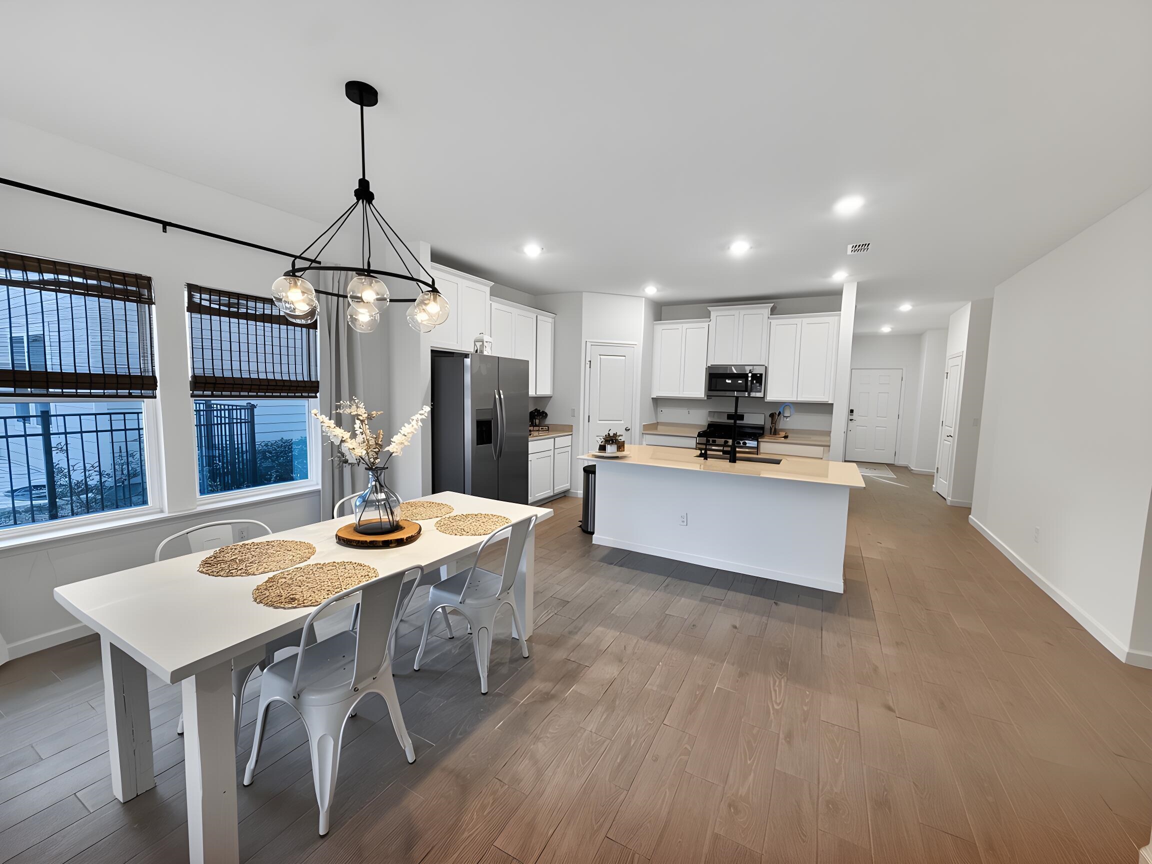 63 Quicksilver Way St. Augustine, FL 32092 - Photo 14 of 36 a kitchen with stainless steel appliances kitchen island granite countertop a table chairs and a refrigerator