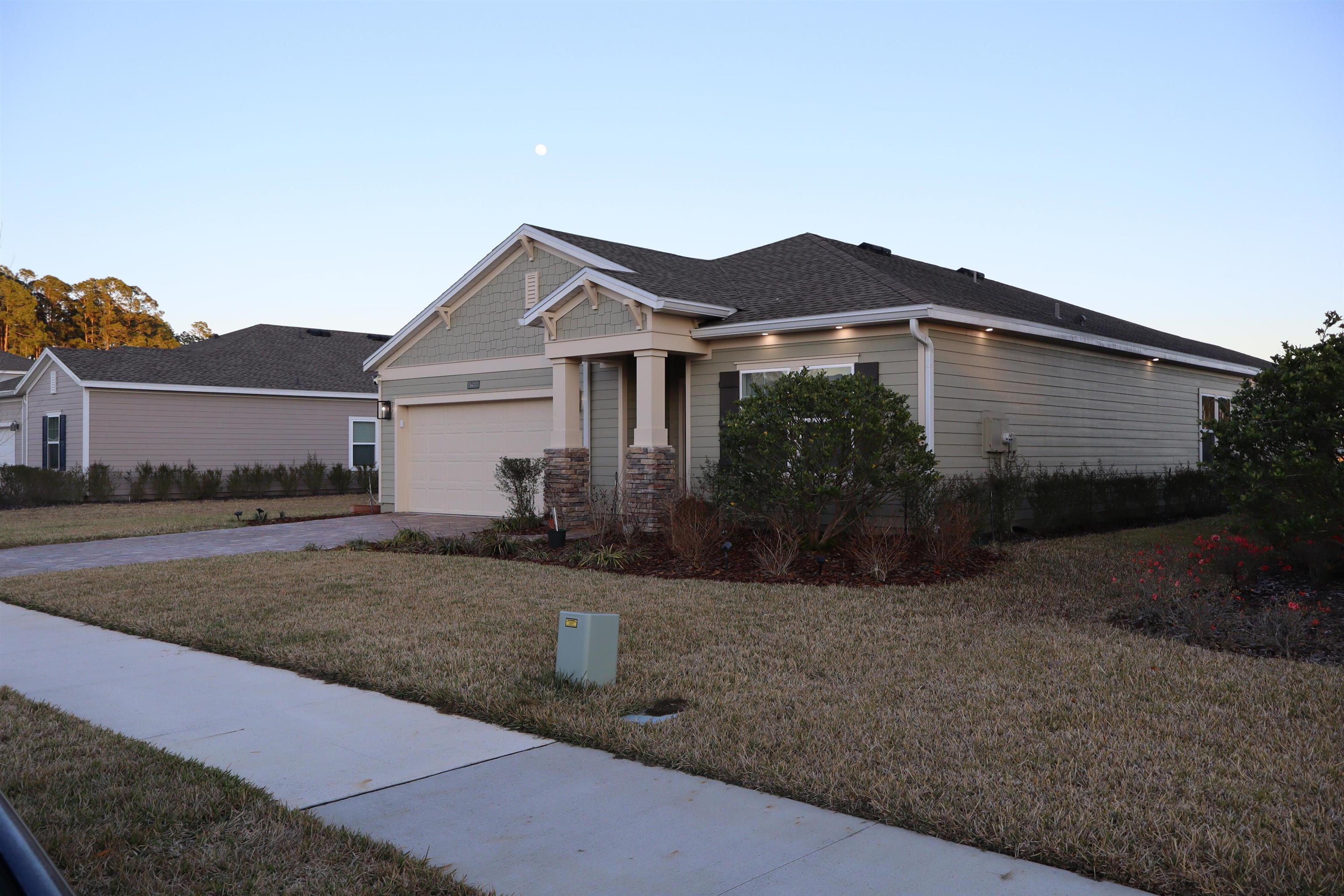 63 Quicksilver Way St. Augustine, FL 32092 - Photo 17 of 36 a front view of a house with a yard and garage