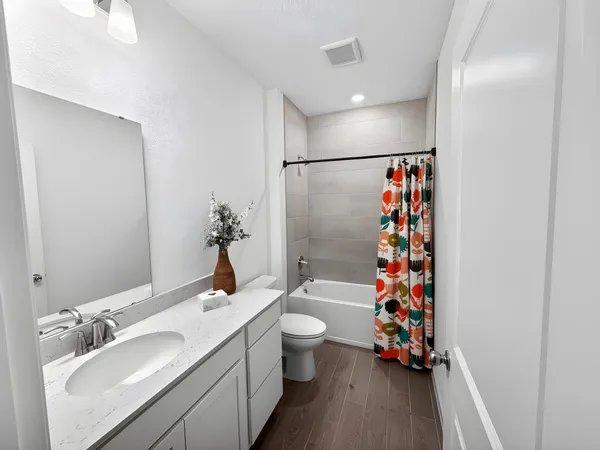 a bathroom with a sink toilet and shower