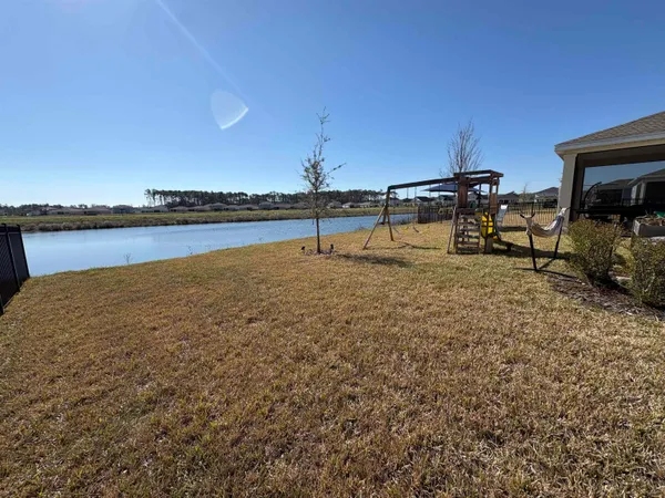 a view of a balcony with chair and wooden floor