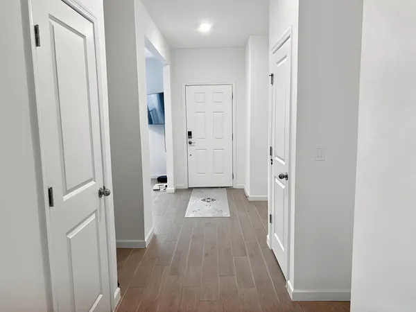 an aerial view of a house with a yard and lake view