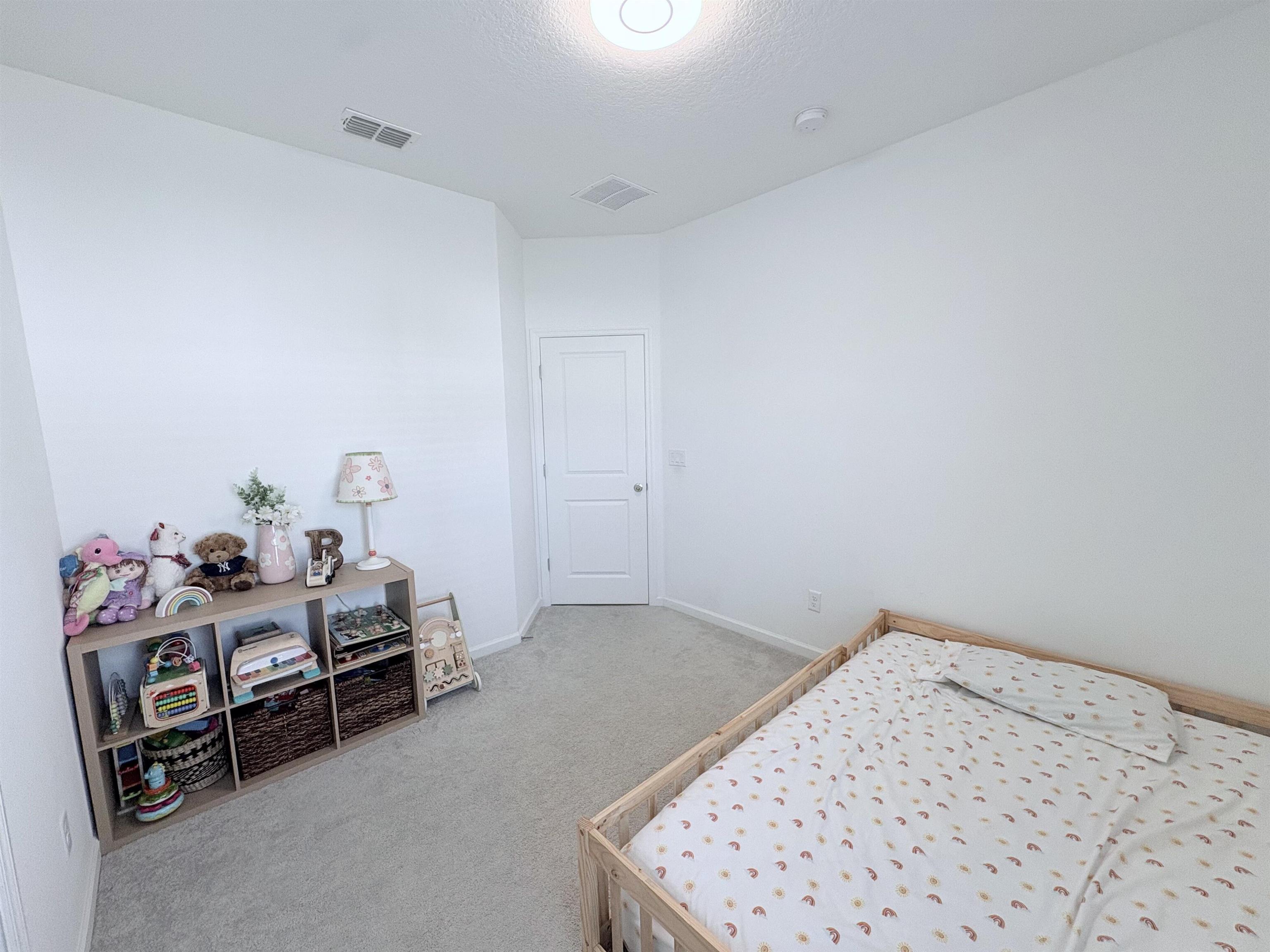 63 Quicksilver Way St. Augustine, FL 32092 - Photo 29 of 36 a bedroom with a bed and a cabinets